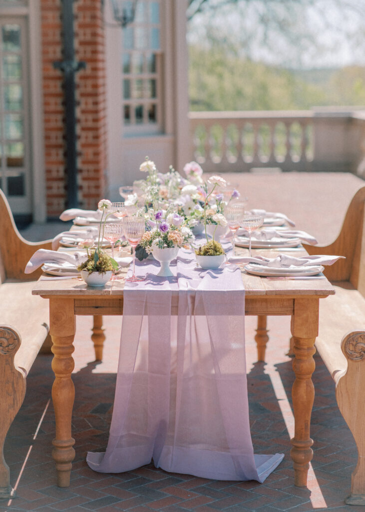 Lilac tablescape on back terrace with floral centerpieces.